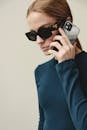 Young Woman in Sunglasses Talking on Modern Smartphone