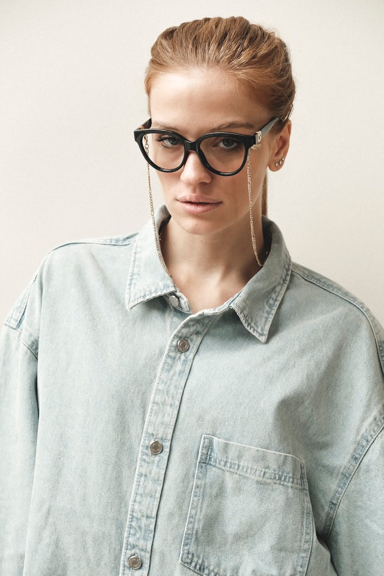 Woman In Glasses Posing In Studio