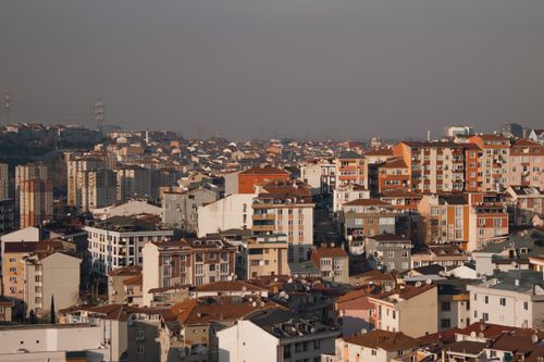 Free A city view showing densely packed residential buildings under a smoggy sky, highlighting urban environmental issues. Stock Photo