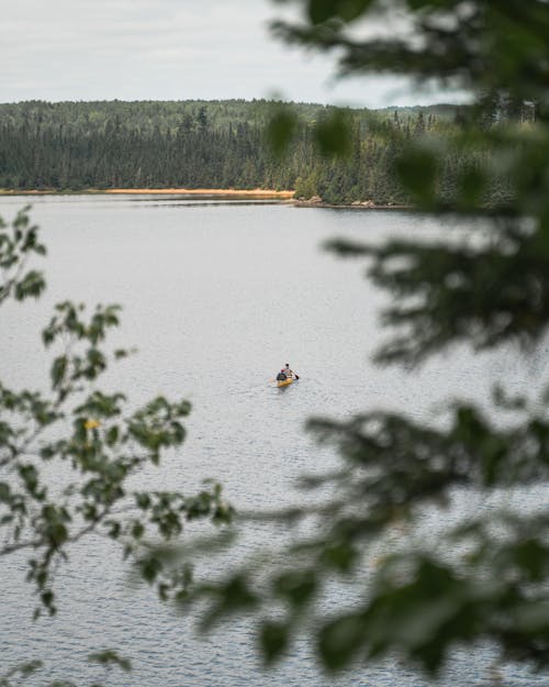 Free View of a Person Canoeing in a Lake Stock Photo