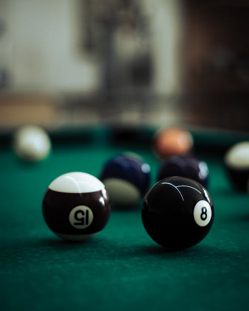 Close-Up Shot of Billiard Balls on Green Surface