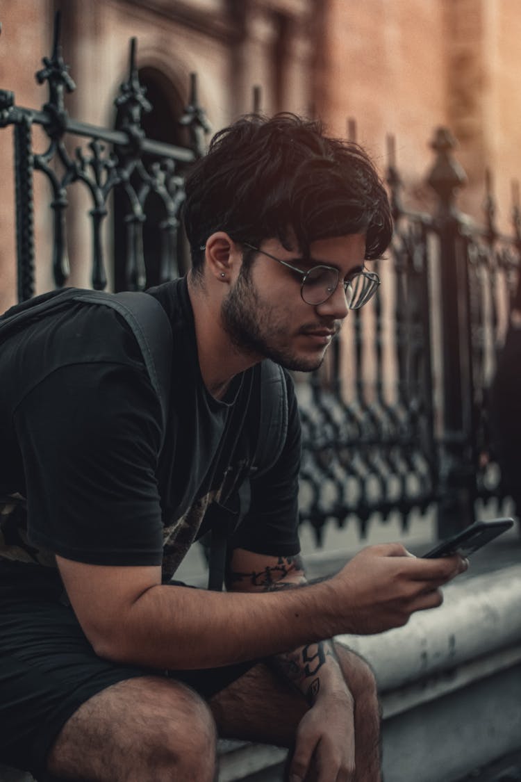 Man Wearing A Black Shirt Texting