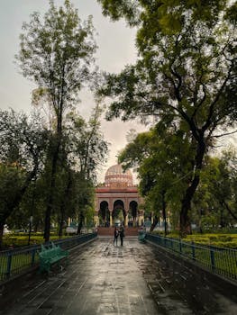 A peaceful view of the Kiosko Morisco with lush greenery in a Mexico City park at dusk.