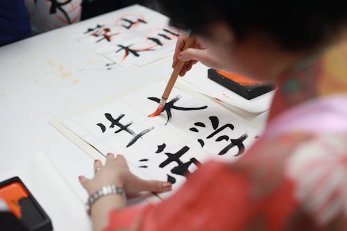Free Person Holding Brush Drawing Kanji Script Stock Photo