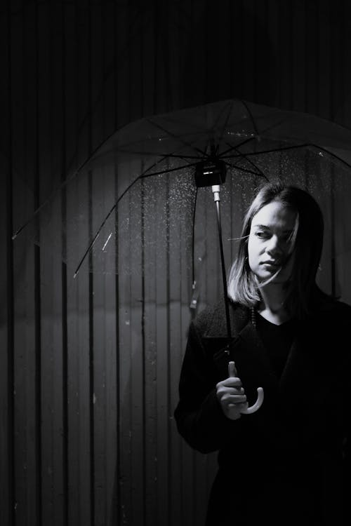 Grayscale Photo of a Woman Holding an Umbrella 