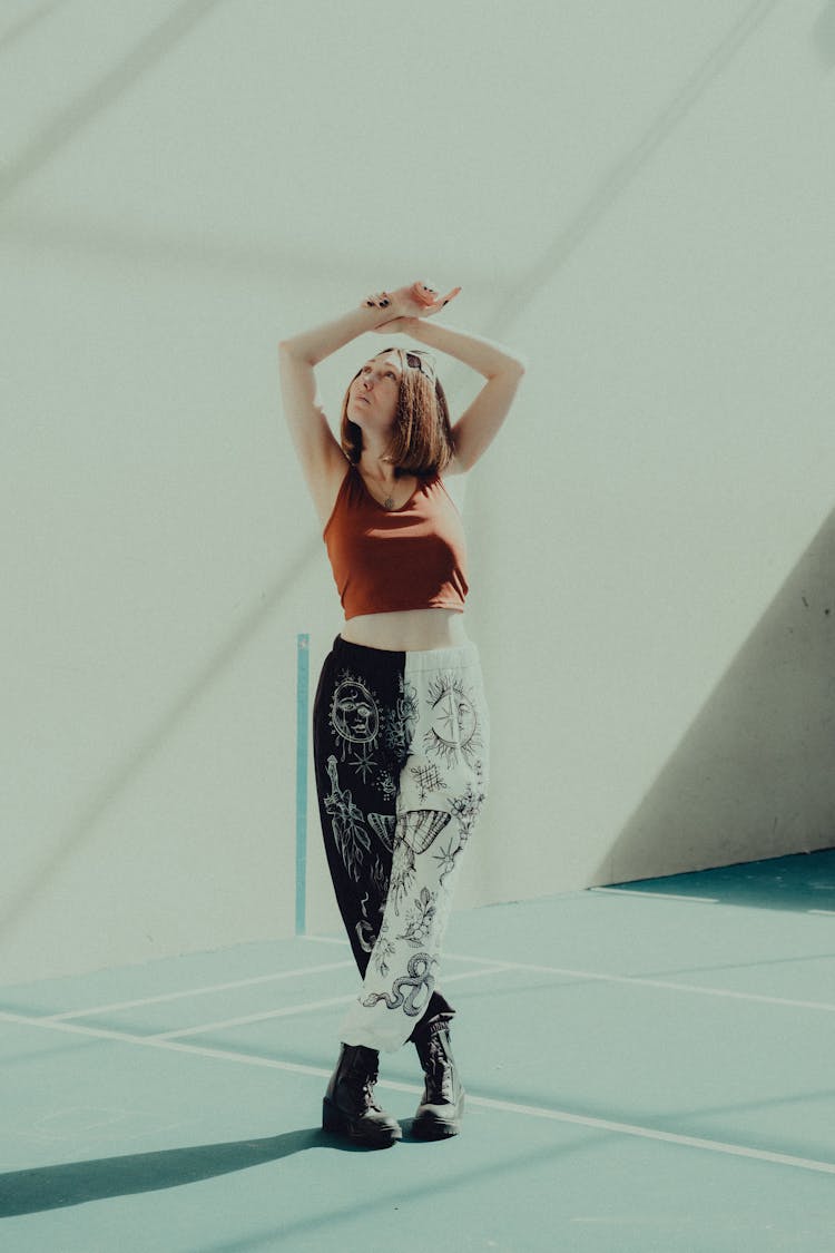 Woman Posing With Arms Raised Above Head