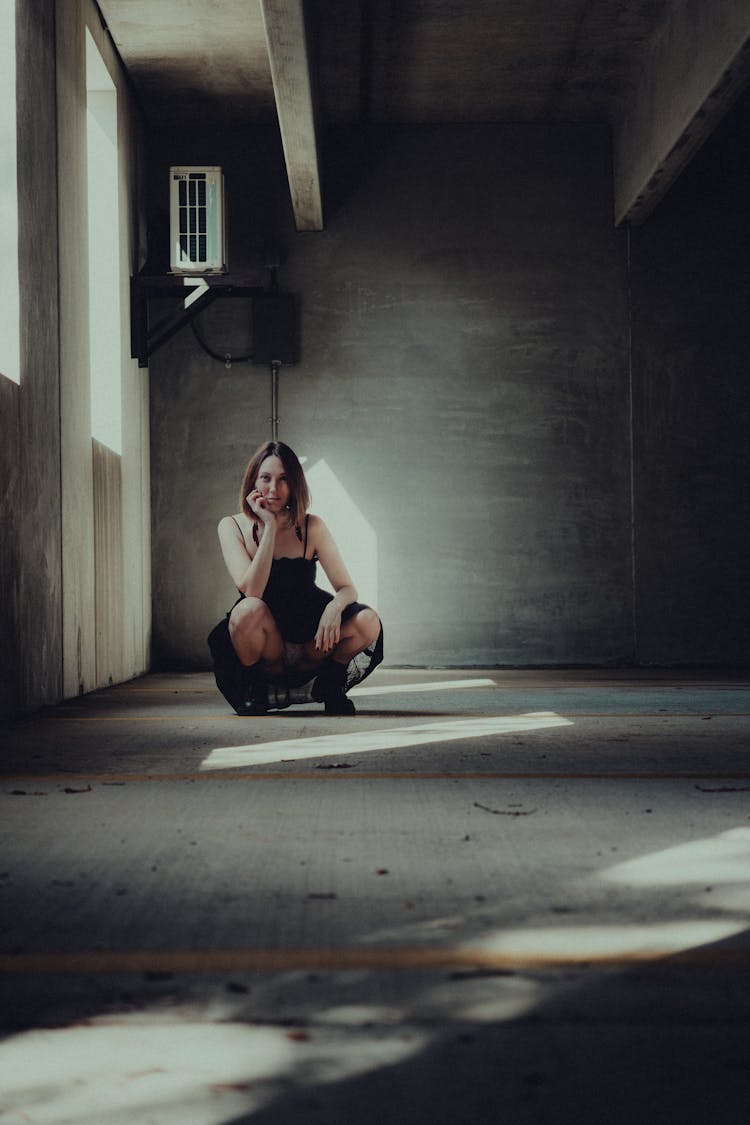 Woman Squatting In Abandoned Building