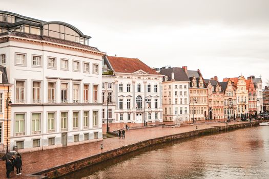 Picturesque view of historic buildings along the Leie River in Ghent, Belgium.