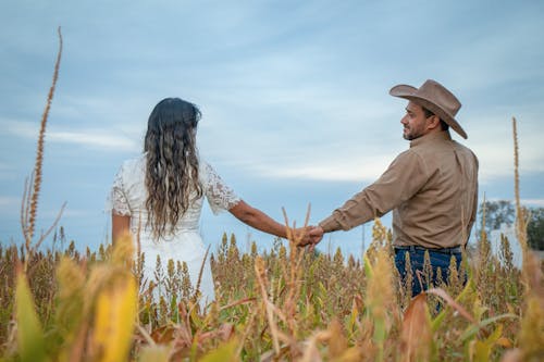 Holding Hands Couple Walking in Cropland