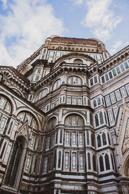 Vibrant low-angle shot of the iconic Duomo's facade in Florence, Italy, showcasing intricate Gothic architecture.