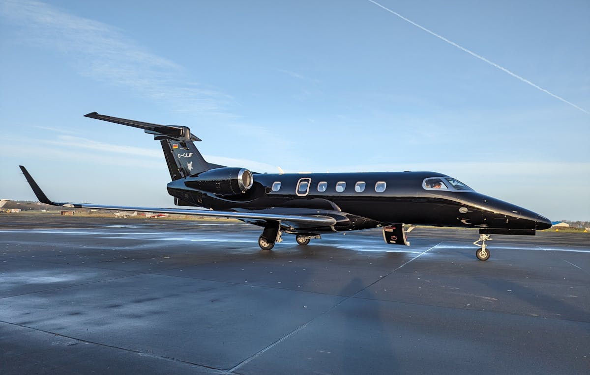 Elegant black private jet parked on a sunny runway