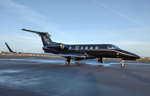 Free Elegant black private jet parked on a sunny runway, showcasing modern luxury aviation. Stock Photo