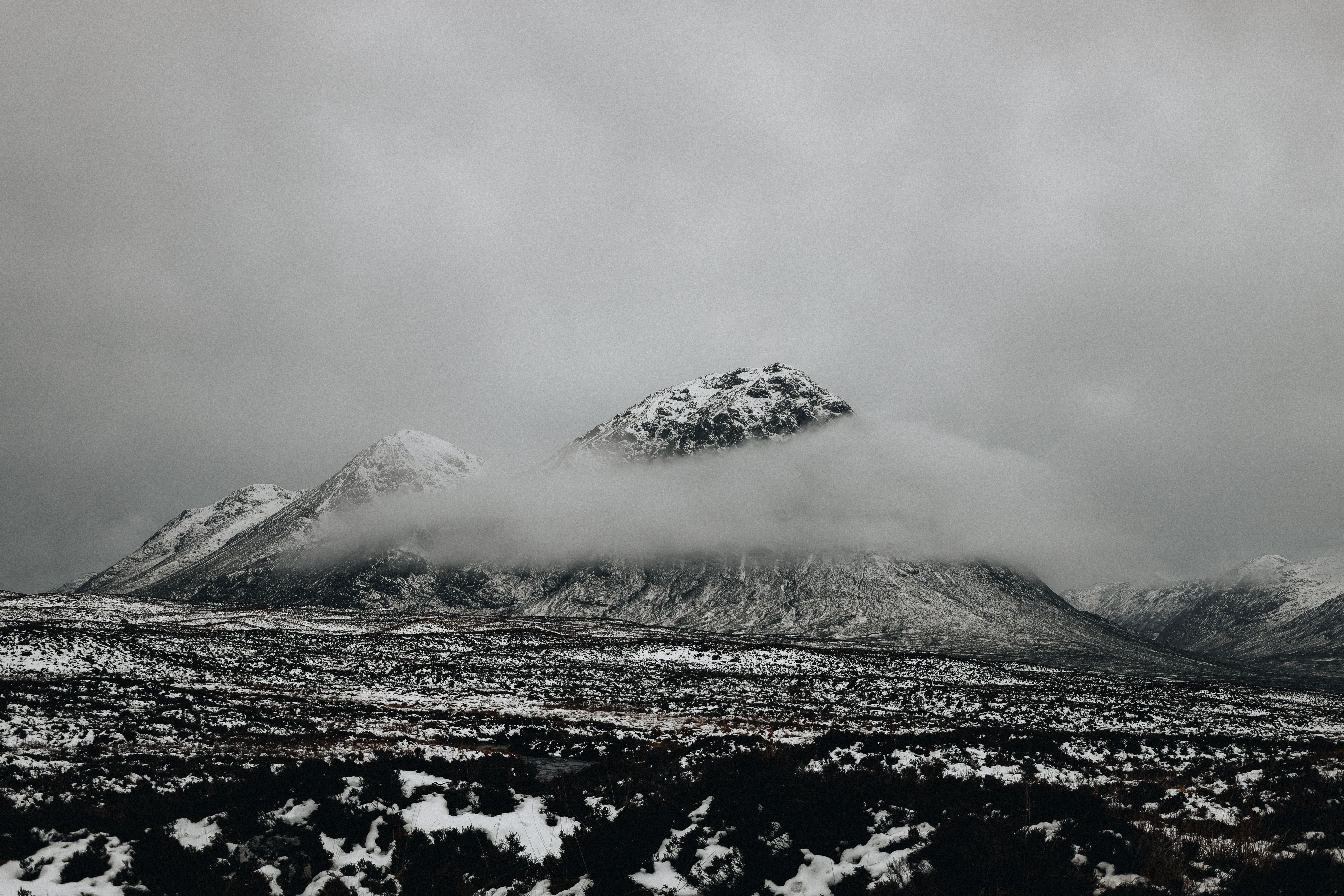 Snow Capped Mountains Under Cloudy Sky · Free Stock Photo