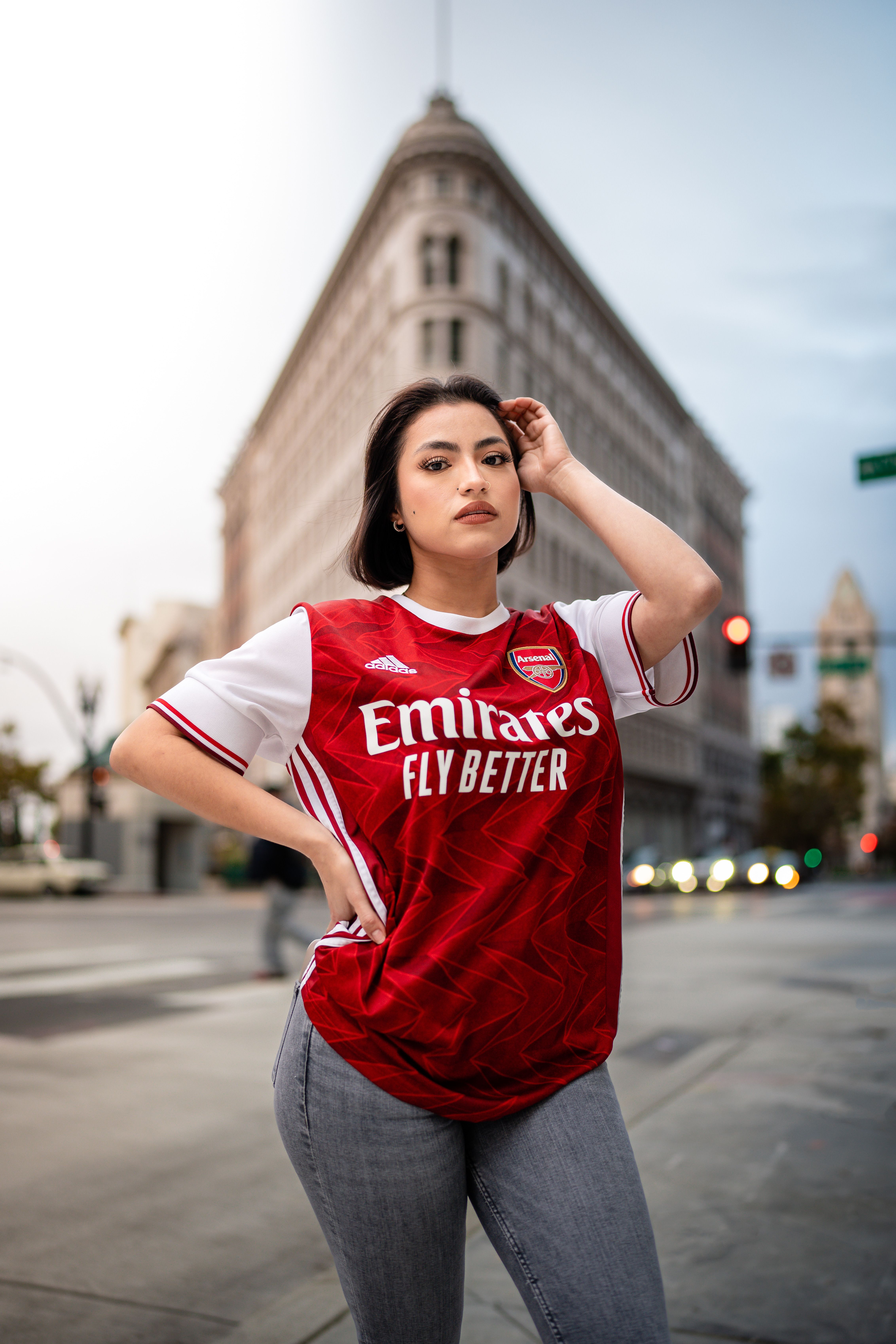 Woman Posing on the Street in Emirates T-shirt · Free Stock Photo
