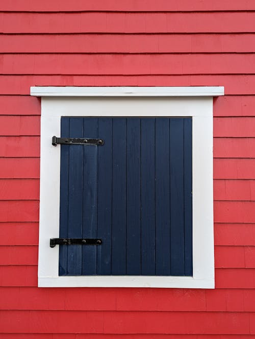 Blue Wooden Door on Red Wall