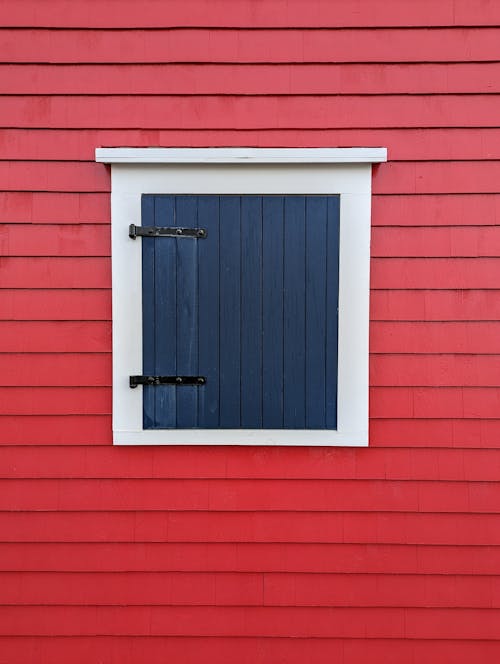 Blue Wooden Door on Red Wall