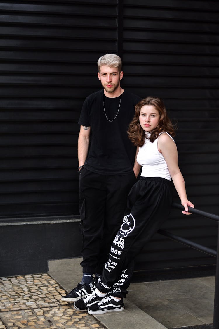 Couple In Casual Street Wear Posing Outdoors