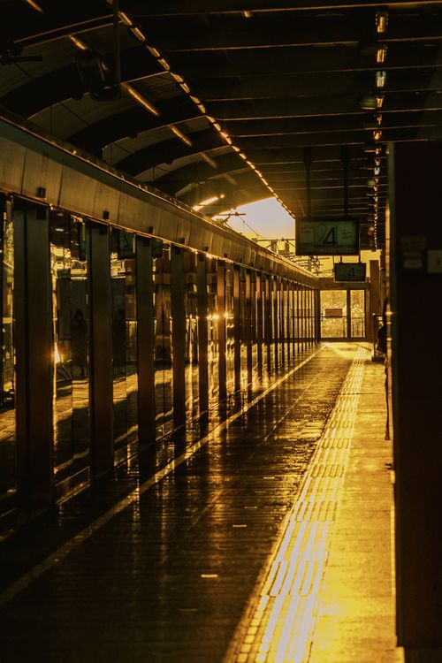 Free Sunlight streaming through an empty subway station hallway, creating a warm and dramatic ambiance. Stock Photo