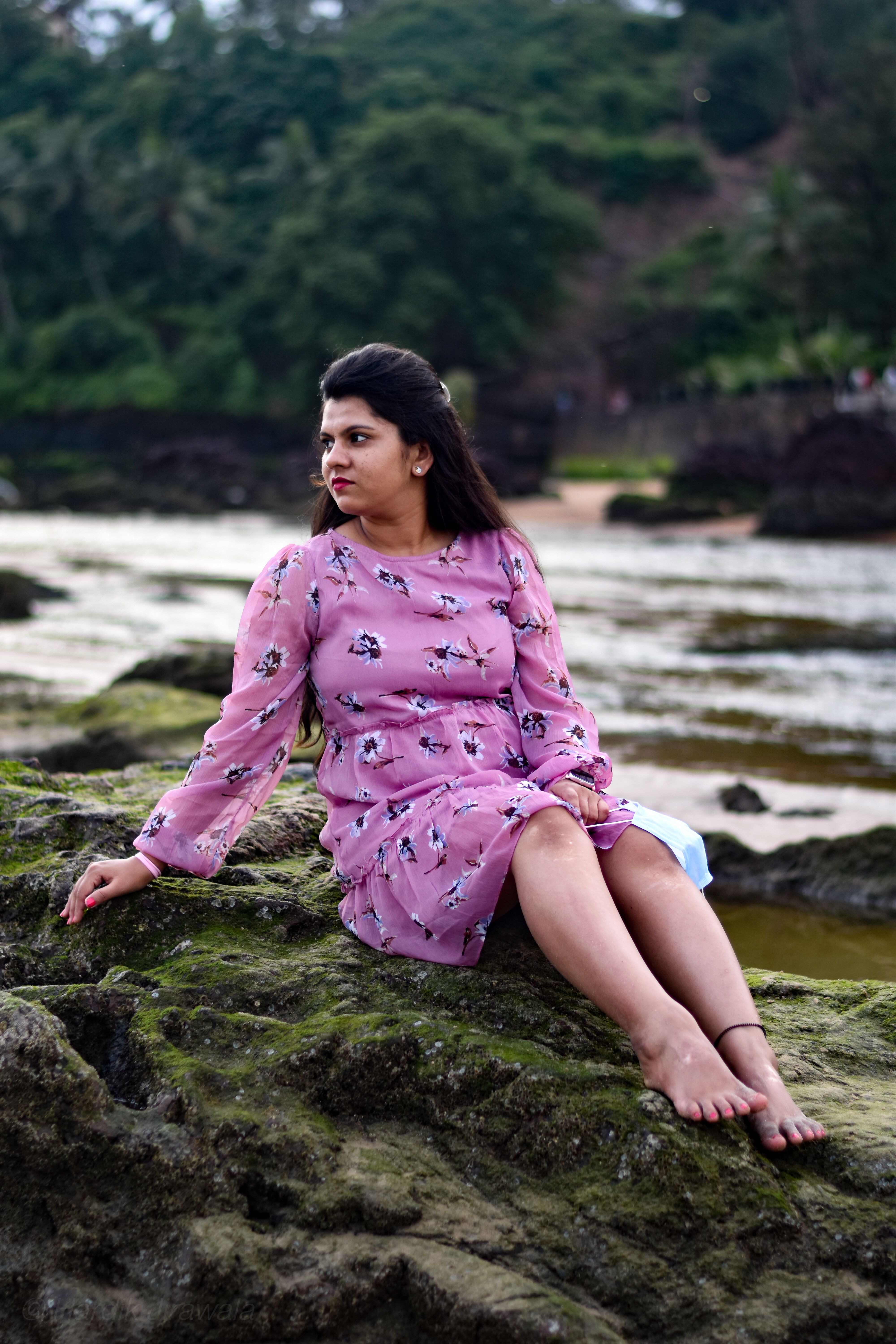 Barefoot Woman Sitting on Rock in Pink Floral Dress · Free Stock Photo