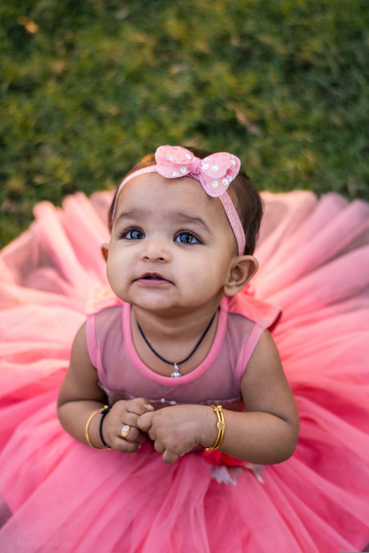 A Baby Girl In A Pink Dress 