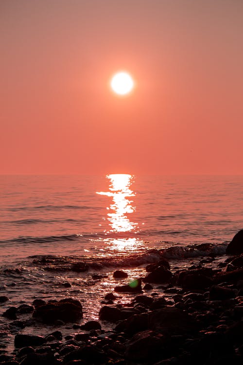 Sun on Clear Sky over Sea Shore at Sunset