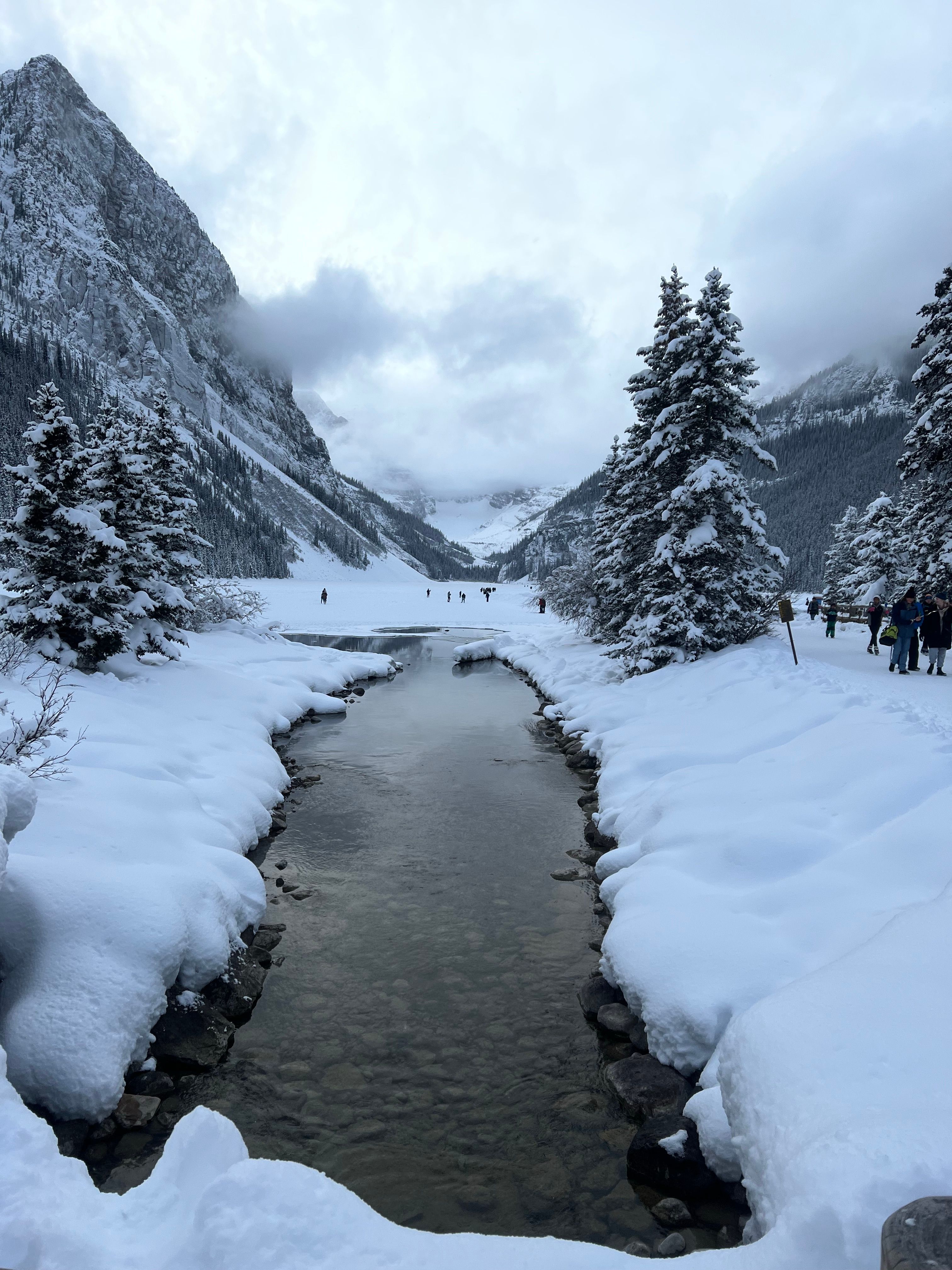 A river running through the snow covered mountains · Free Stock Photo
