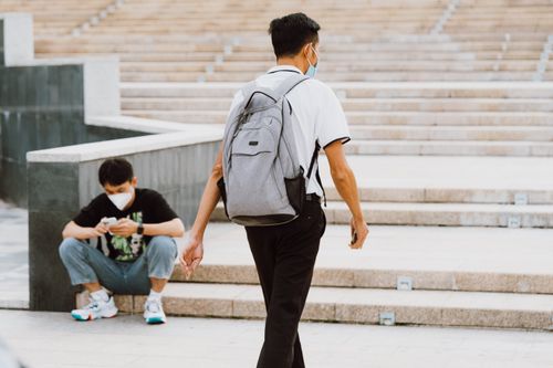 Free Two men wearing face masks in a city setting, focusing on stairs and urban lifestyle. Stock Photo