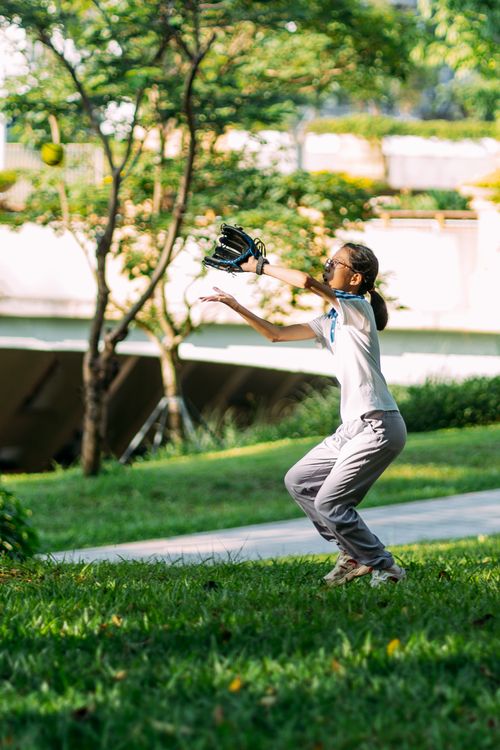 Free Child enjoying a sunny day playing catch with a baseball glove in the park. Stock Photo