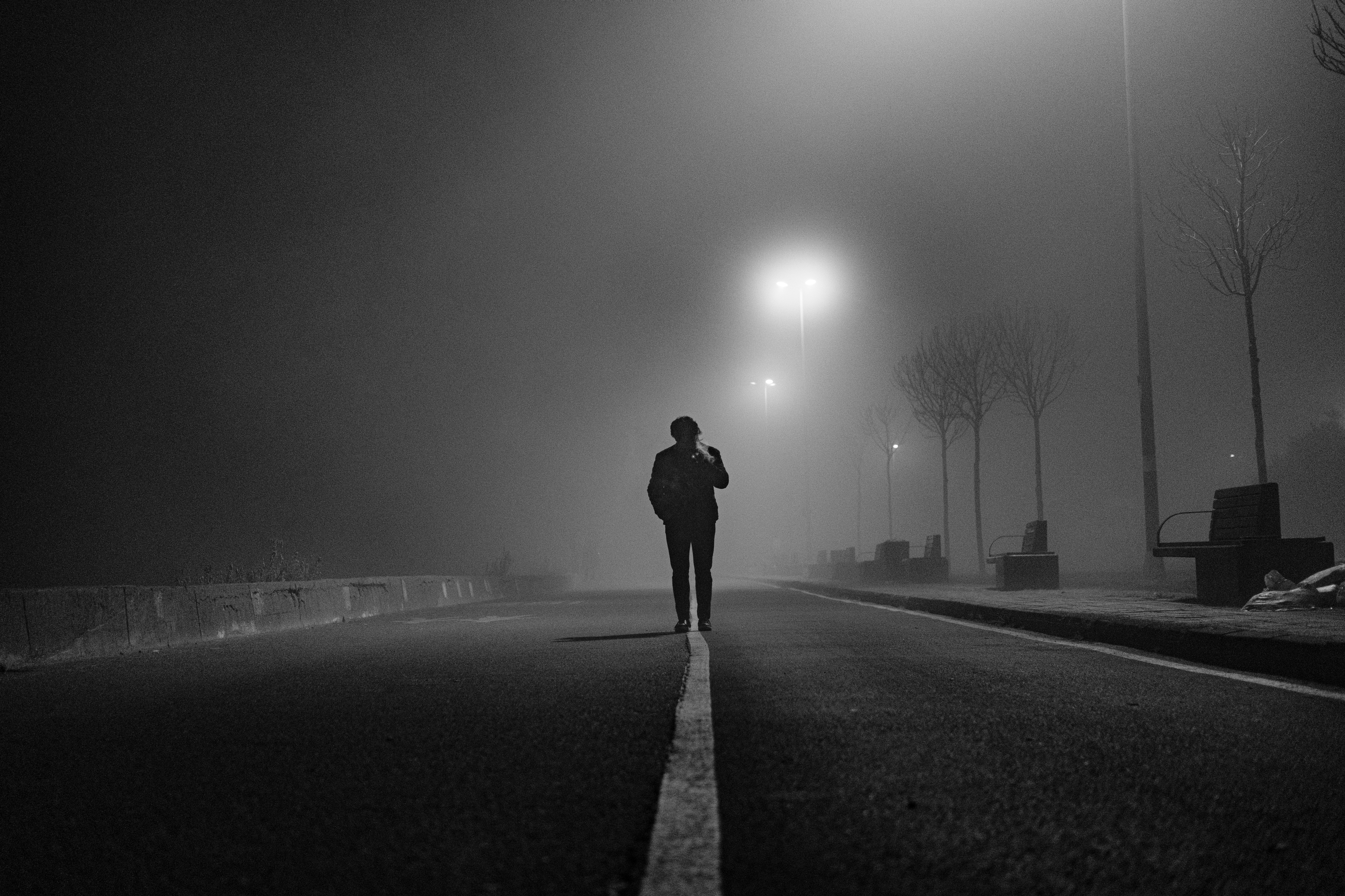 A Man Standing in the Middle of a Road · Free Stock Photo