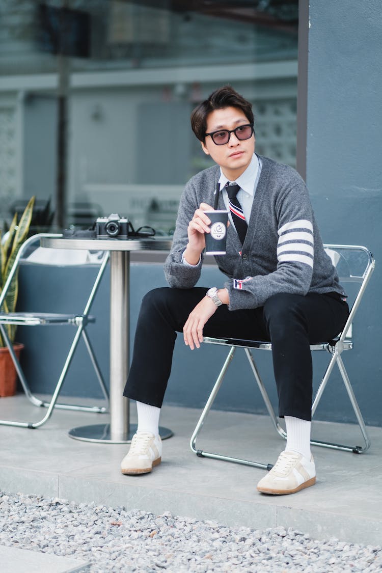 Man Sitting With Cup