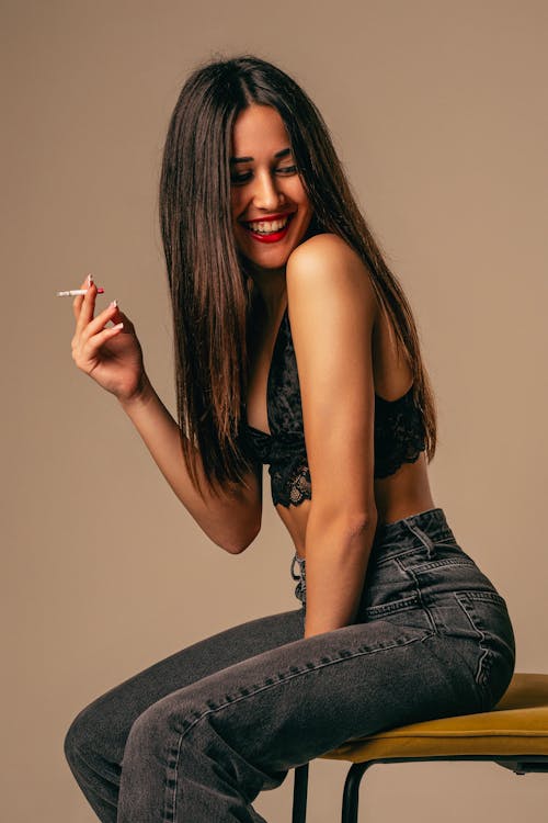 Woman in Black Crop Top Smoking Cigarette