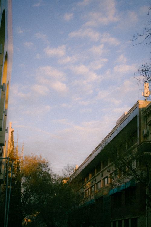 Free Beautiful urban street view with blue sky and building facades at sunset. Stock Photo