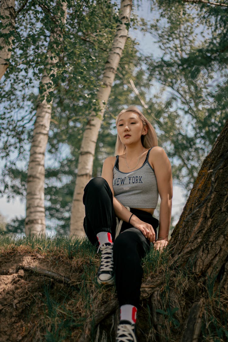 Blonde Woman Sitting On Tree