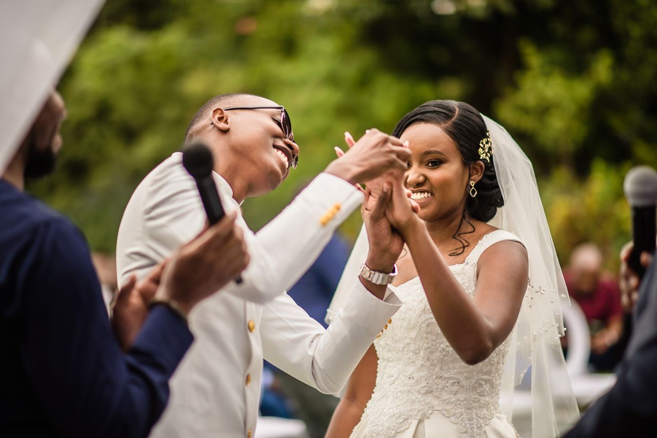 african couple deeply in love dancing and smiling at their wedding cer