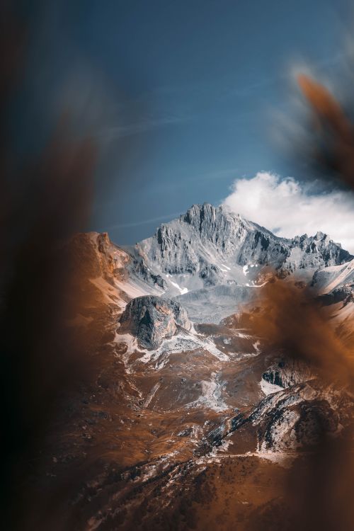 Free A breathtaking view of an alpine mountain landscape during autumn with a clear sky. Stock Photo
