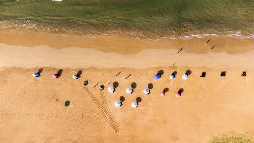 Free Stunning aerial photo of colorful beach umbrellas on the sandy shores of Bentota, Sri Lanka. Stock Photo