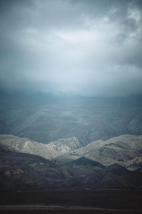 Free Dramatic mountain landscape in Shahrud, Iran with cloudy skies and mist. Stock Photo