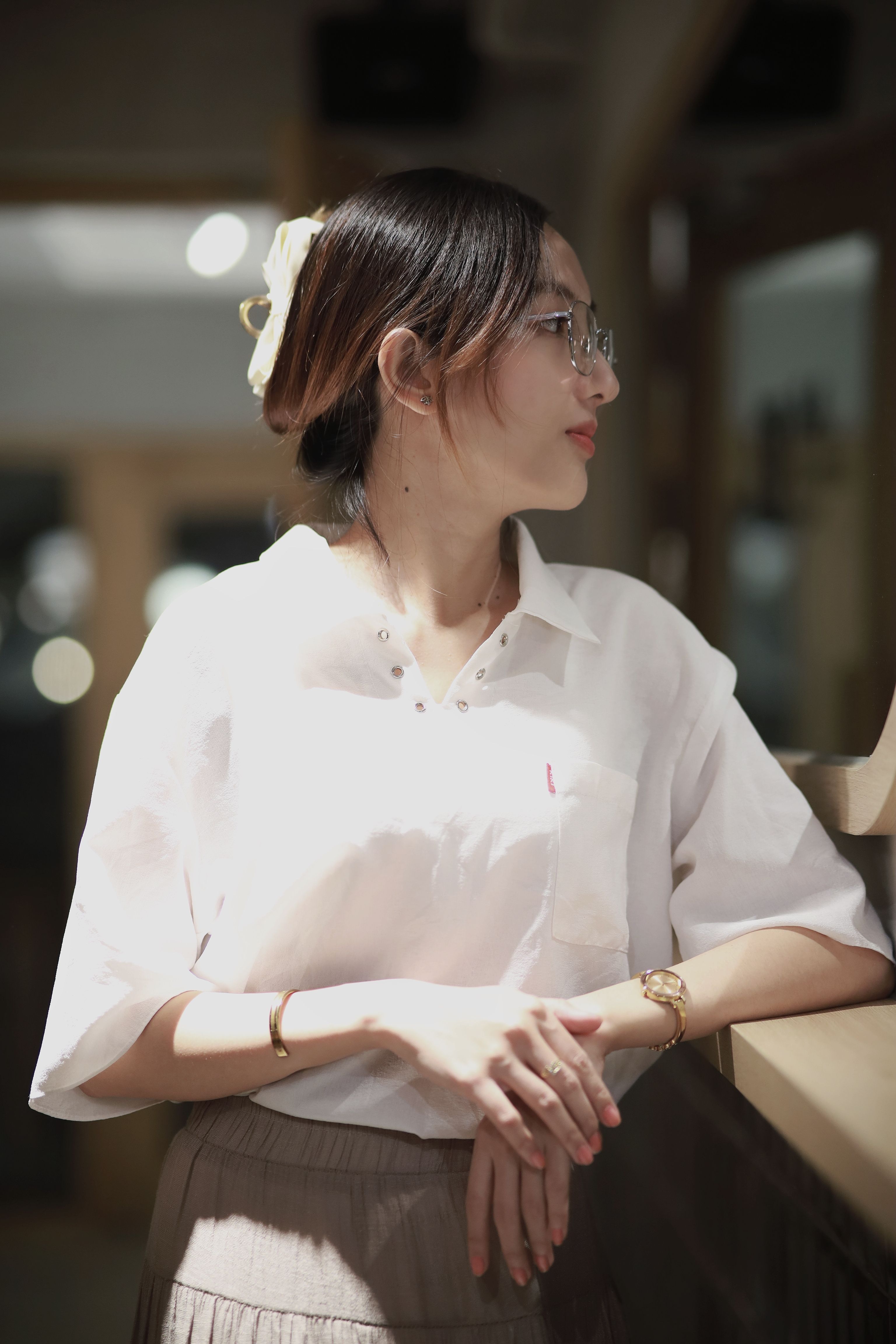 A Woman in a White Shirt Looking Outside the Window · Free Stock Photo