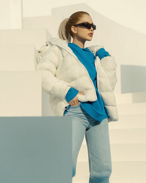 A Woman in White Puffer Jacket Wearing Sunglasses