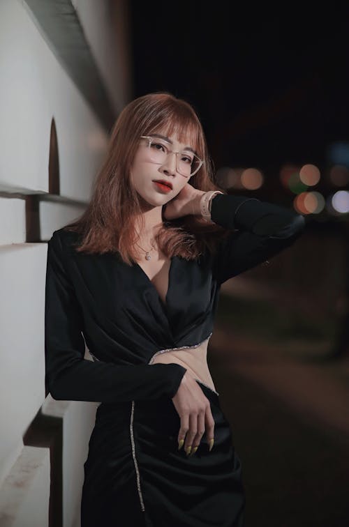 Young Woman in Glasses Posing on Night Street