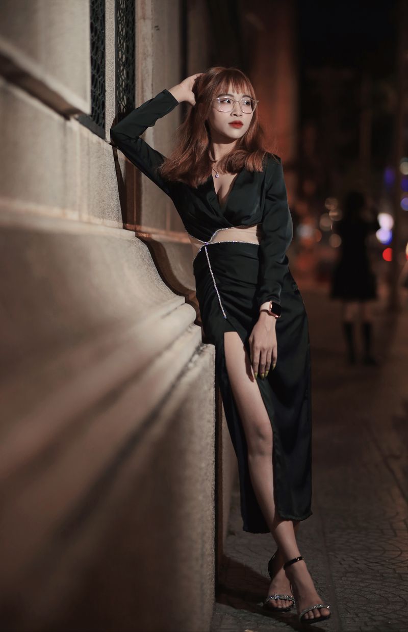 Woman in black dress on night street, office to date night outfit