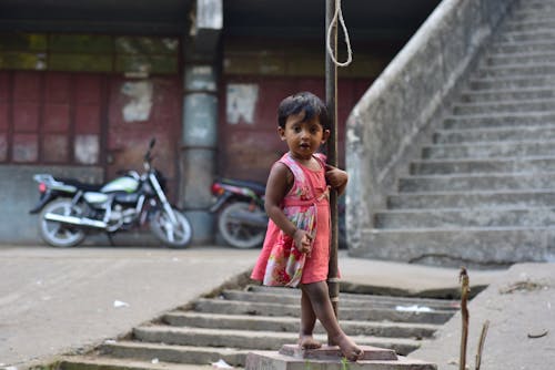 Free Girl Holding on a Post Stock Photo