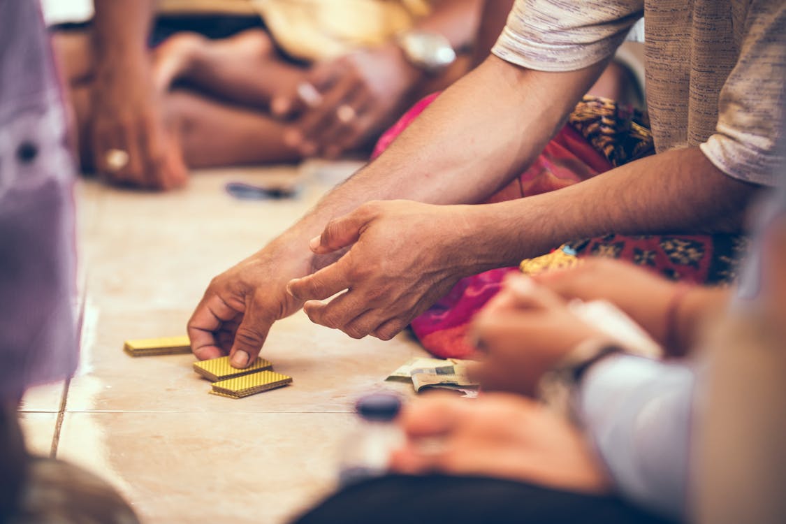 Close-up Photo of a Person's Hand Holding Playing Cards