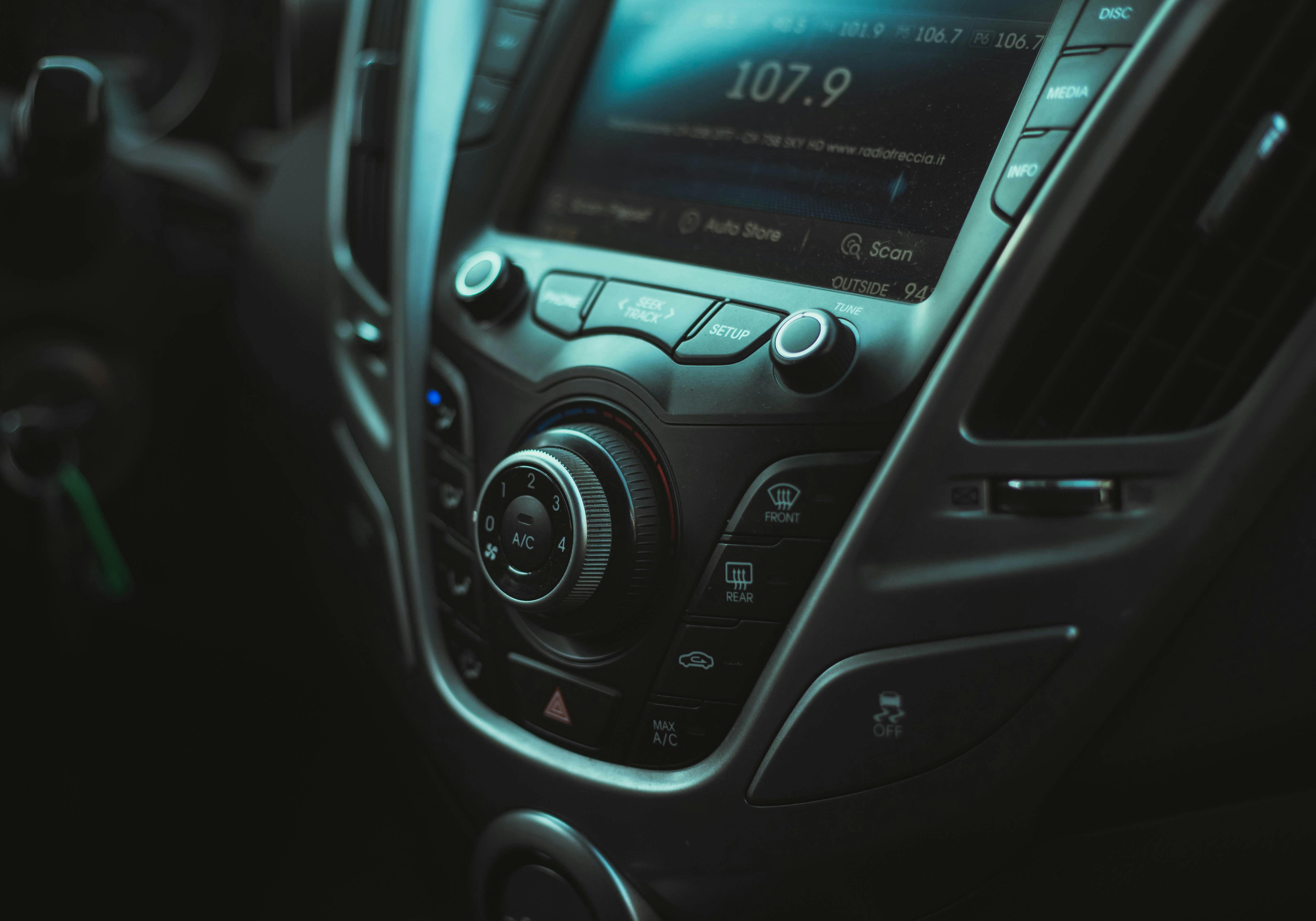 photo of a car interior with a radio buttons and air vent