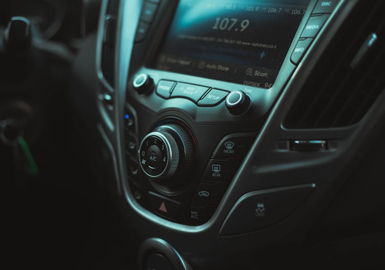 Photo Of A Car Interior With A Radio, Buttons And Air Vent