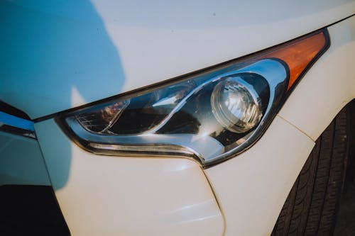 Close-Up Shot of White Car Headlight