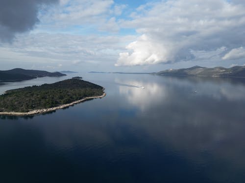 Body of Water Under Cloudy Sky