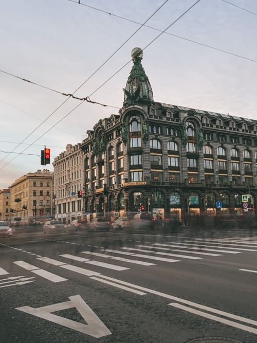 Free Historic architecture at a busy intersection in Nevsky Prospect, Saint Petersburg, with blurred motion of people and vehicles. Stock Photo