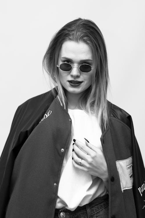 Grayscale Photo of a Woman Wearing Sunglasses