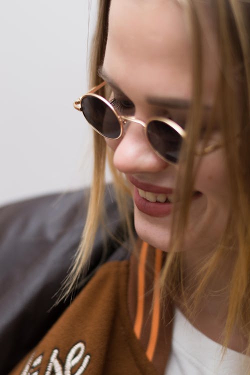 A Woman With Sunglasses Smiling 